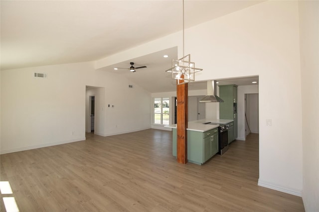 kitchen with visible vents, light countertops, light wood-style floors, green cabinets, and wall chimney exhaust hood