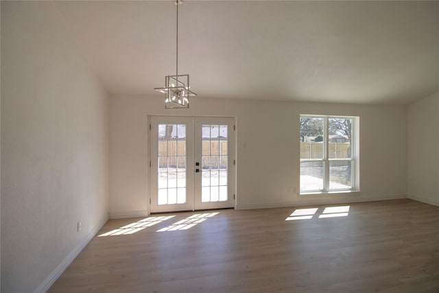 entryway featuring wood finished floors, french doors, and baseboards