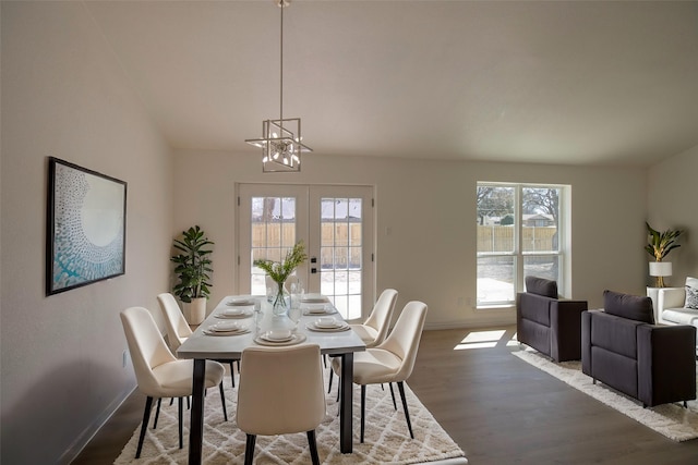 dining area with wood finished floors, french doors, a chandelier, and baseboards