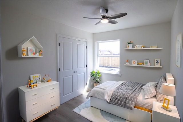 bedroom featuring a closet, dark wood-type flooring, and ceiling fan