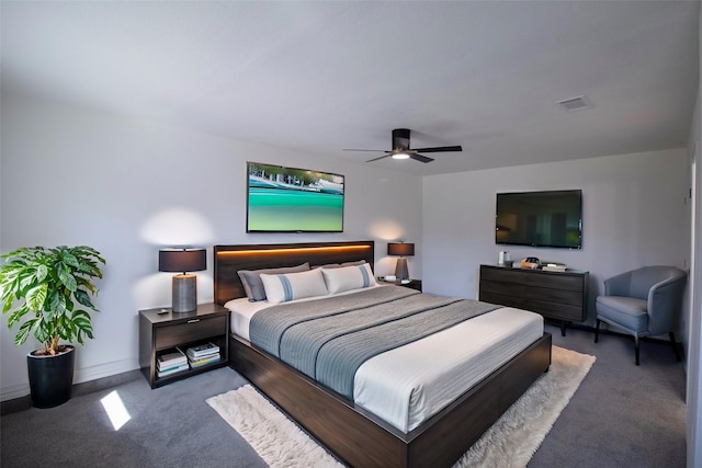 carpeted bedroom with a ceiling fan, visible vents, and baseboards