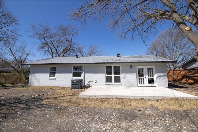 rear view of house featuring a patio, fence, french doors, and brick siding