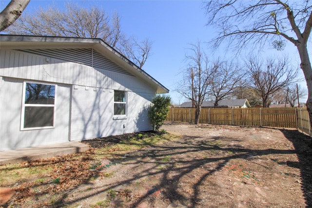 view of side of home with fence