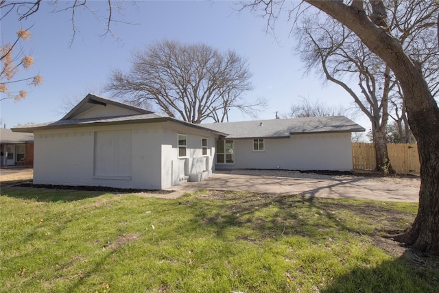 back of property featuring a patio area, brick siding, a yard, and fence