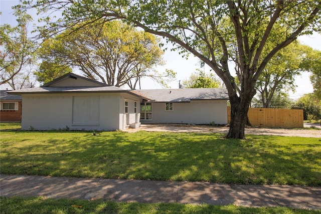exterior space with fence, a yard, and a patio