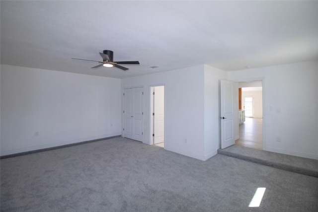 unfurnished bedroom featuring baseboards, carpet floors, and ceiling fan