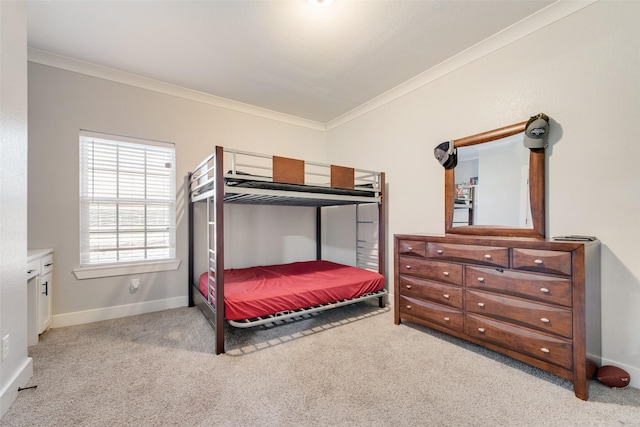 bedroom with baseboards, crown molding, and carpet