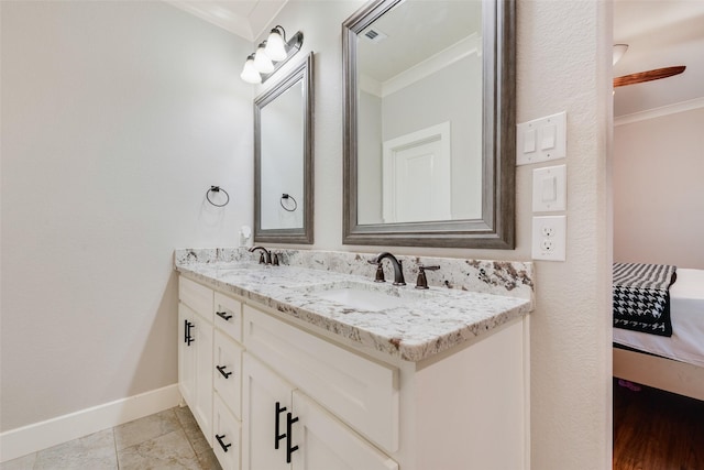 full bath with a sink, connected bathroom, and ornamental molding