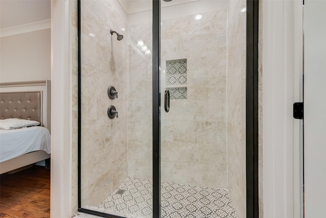 ensuite bathroom with ensuite bath, wood finished floors, and a stall shower