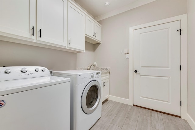 laundry room with ornamental molding, cabinet space, independent washer and dryer, and baseboards