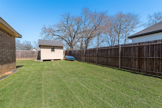 view of yard with an outbuilding, a storage shed, and a fenced backyard