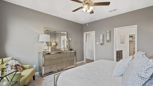 carpeted bedroom with visible vents, baseboards, ceiling fan, and a spacious closet