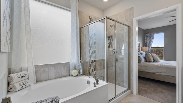 bathroom featuring a stall shower, ensuite bathroom, and a garden tub