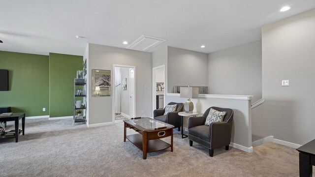 sitting room featuring recessed lighting, baseboards, and light carpet