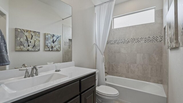 bathroom featuring vanity, toilet, and shower / tub combo with curtain