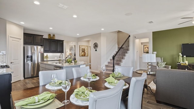 dining room featuring visible vents, wood finish floors, ceiling fan, stairway, and recessed lighting