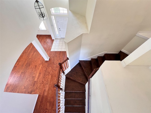 staircase with tile patterned flooring and baseboards