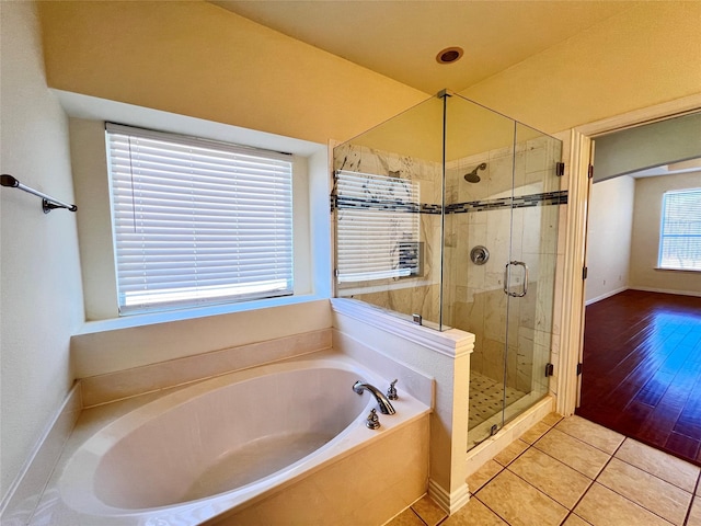 full bath with tile patterned floors, a shower stall, and a garden tub