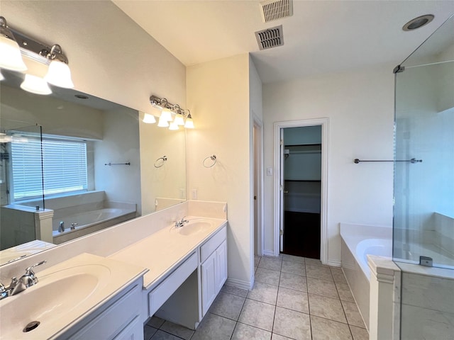 full bath with double vanity, a bath, visible vents, and a sink