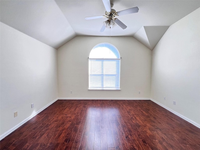 unfurnished room with ceiling fan, baseboards, lofted ceiling, and wood finished floors