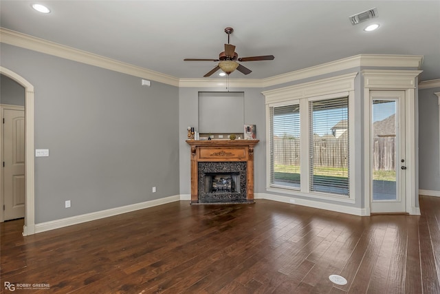 unfurnished living room featuring hardwood / wood-style floors, baseboards, visible vents, a fireplace, and ornamental molding