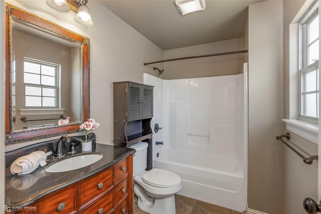 full bath featuring a wealth of natural light, toilet, vanity, and shower / bathing tub combination