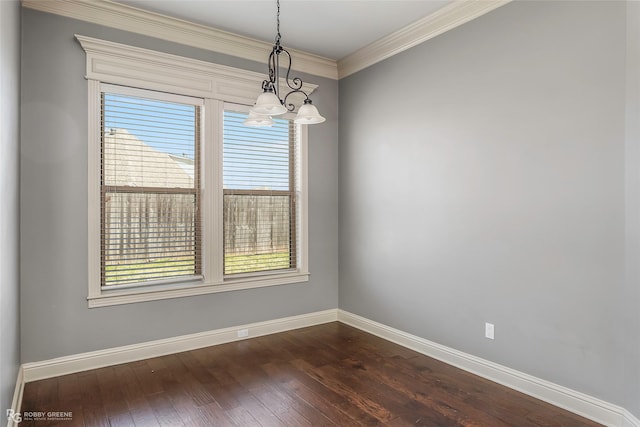 spare room featuring baseboards, plenty of natural light, dark wood-type flooring, and crown molding