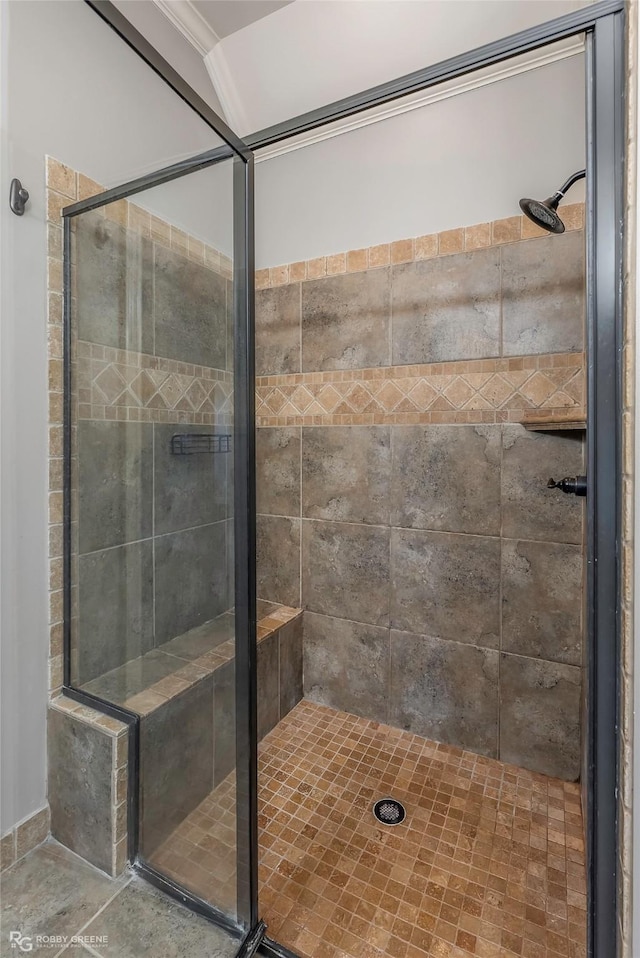 full bathroom with a stall shower and crown molding