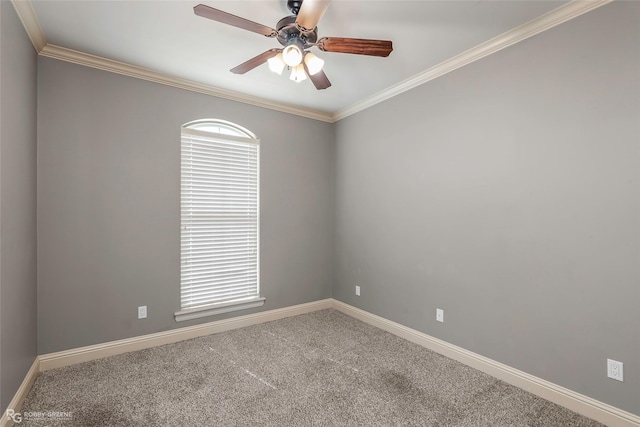 carpeted empty room with ceiling fan, crown molding, and baseboards