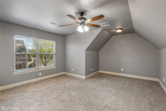 additional living space featuring visible vents, carpet flooring, and vaulted ceiling