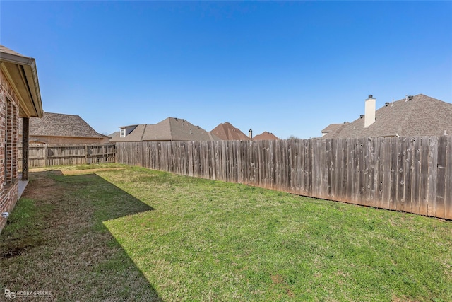 view of yard with a fenced backyard