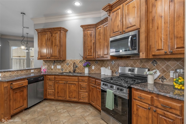 kitchen with ornamental molding, a sink, stainless steel appliances, a peninsula, and brown cabinetry