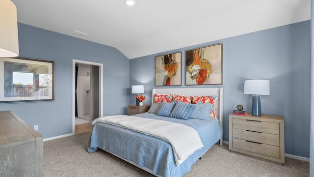 carpeted bedroom with vaulted ceiling and baseboards