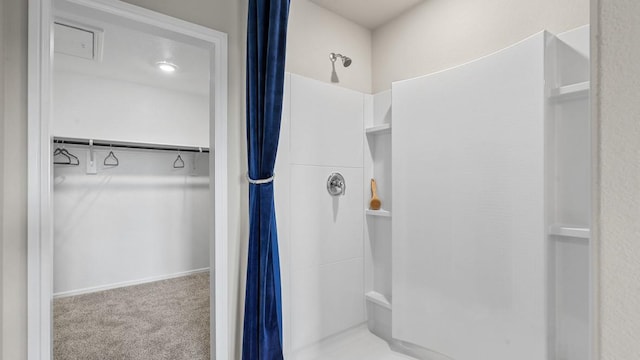 bathroom featuring a shower with shower curtain and a spacious closet