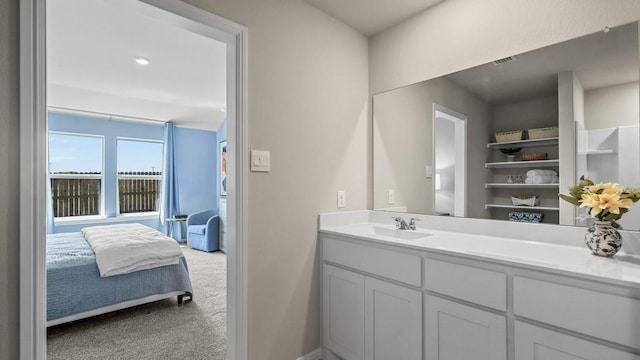 bathroom featuring visible vents, vanity, and ensuite bathroom