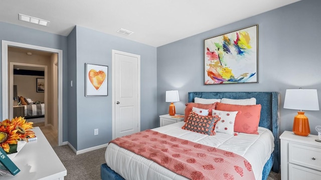 carpeted bedroom featuring visible vents and baseboards