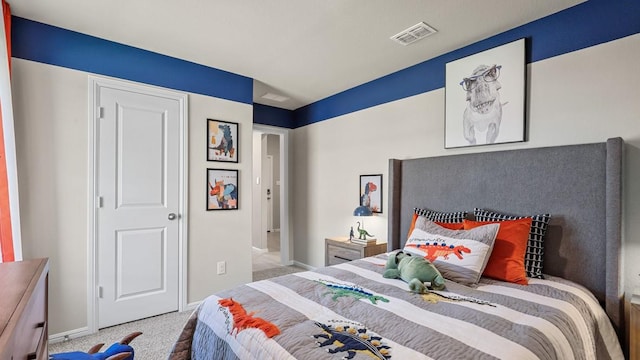 carpeted bedroom with baseboards and visible vents