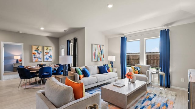 living area featuring recessed lighting, light wood-type flooring, and baseboards