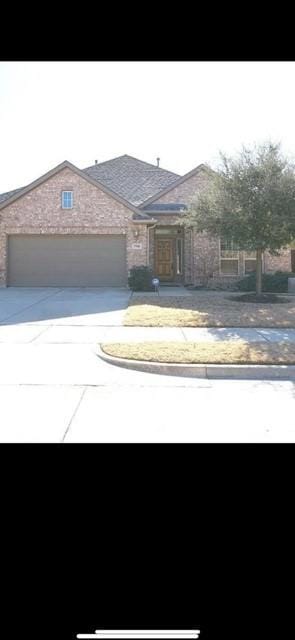 view of front of property with concrete driveway and a garage