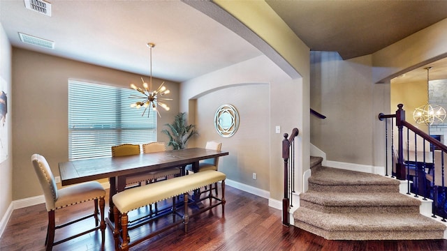 dining space with baseboards, visible vents, dark wood-style flooring, and a chandelier