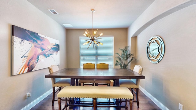 dining space featuring dark wood-style floors, visible vents, a chandelier, and baseboards