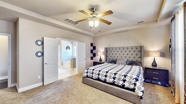 bedroom with visible vents, baseboards, carpet, and a tray ceiling