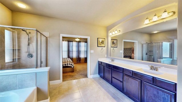 full bathroom featuring tile patterned flooring, double vanity, a stall shower, ensuite bath, and a sink