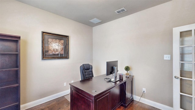 office space featuring dark wood finished floors, baseboards, and visible vents