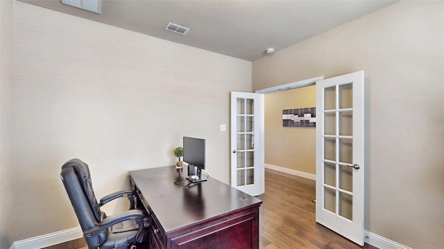 home office with visible vents, french doors, baseboards, and wood finished floors