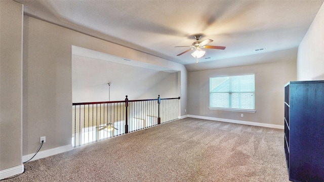 spare room featuring baseboards, carpet, visible vents, and ceiling fan