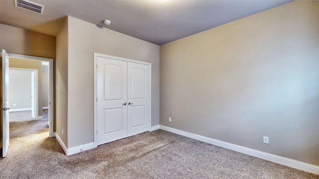 unfurnished bedroom featuring visible vents, baseboards, and carpet flooring