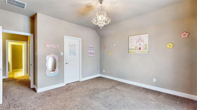 unfurnished room with visible vents, baseboards, lofted ceiling, carpet floors, and a notable chandelier