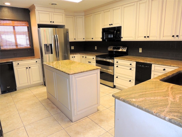 kitchen with tasteful backsplash, a kitchen island, light tile patterned floors, light stone counters, and black appliances