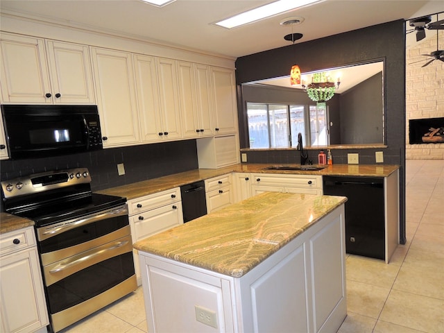 kitchen with a center island, light tile patterned floors, decorative backsplash, black appliances, and a sink